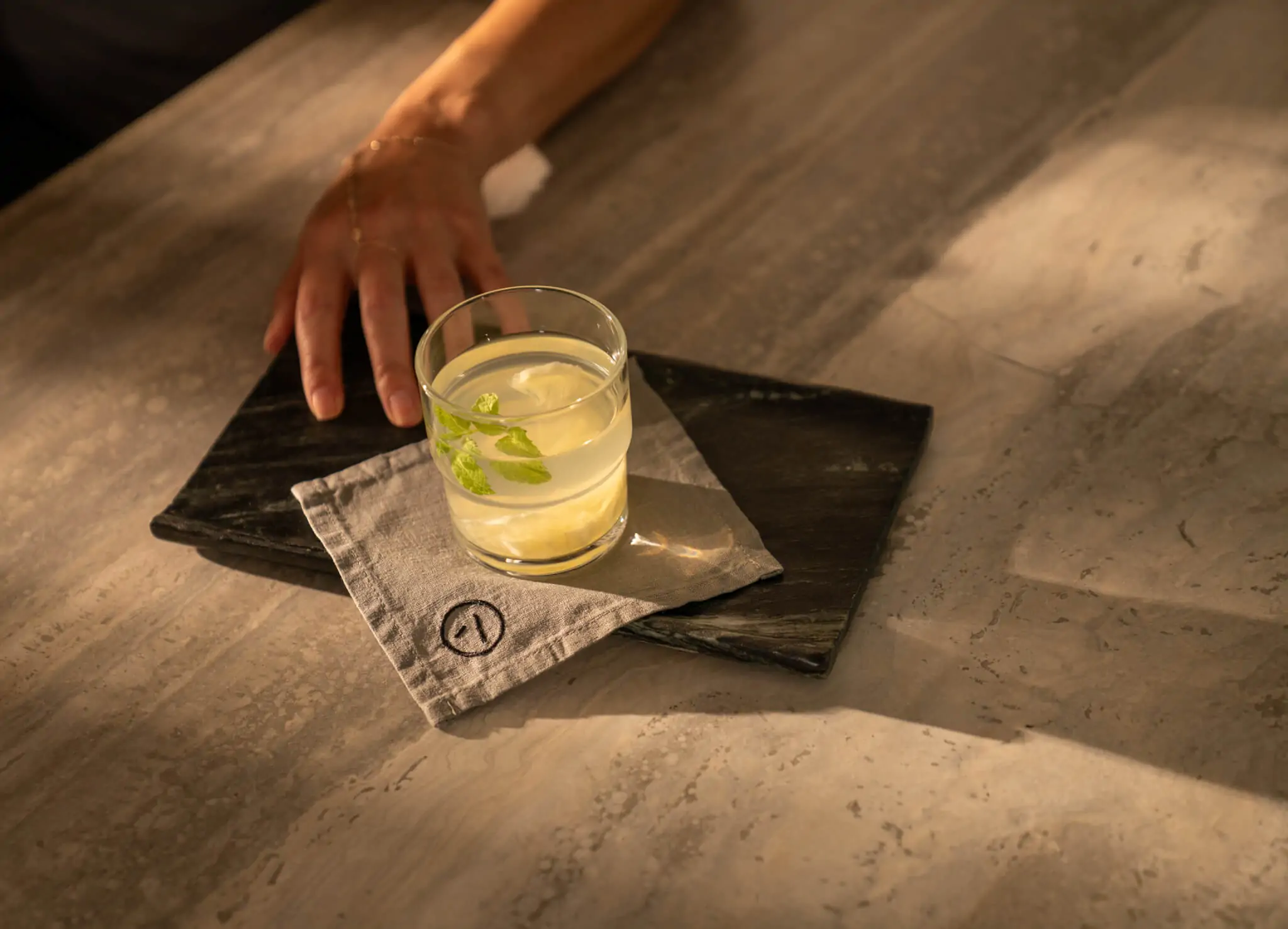 Alchemy photoshoot drinks with branded napkin with Alchemy logomark