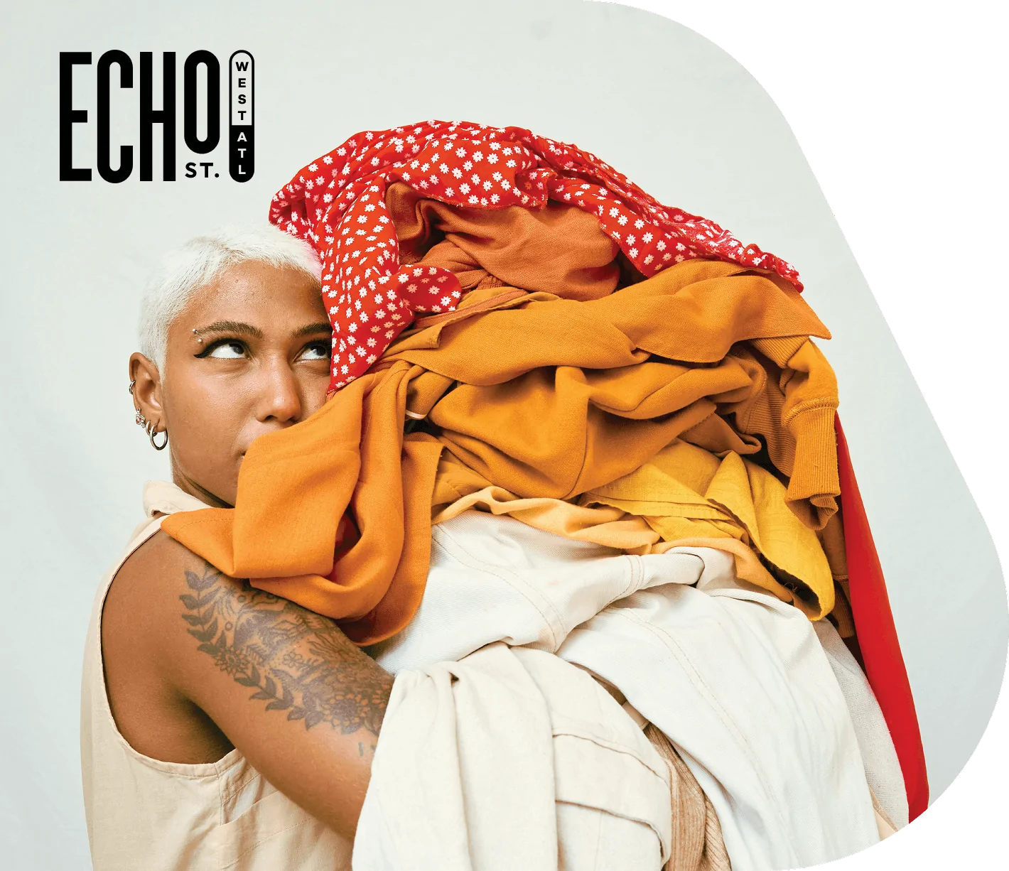 Echo St. West Atlanta logo over image of woman holding load of laundry