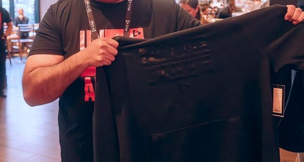 Person holding up their Summit Shirt